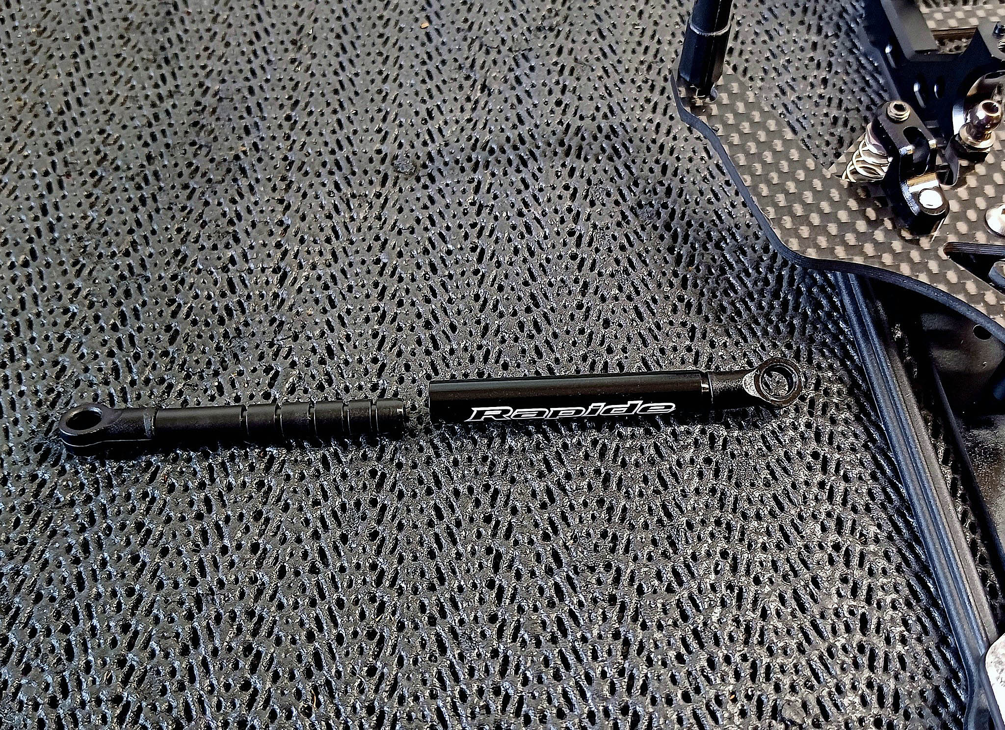 A black metal object on a black surface